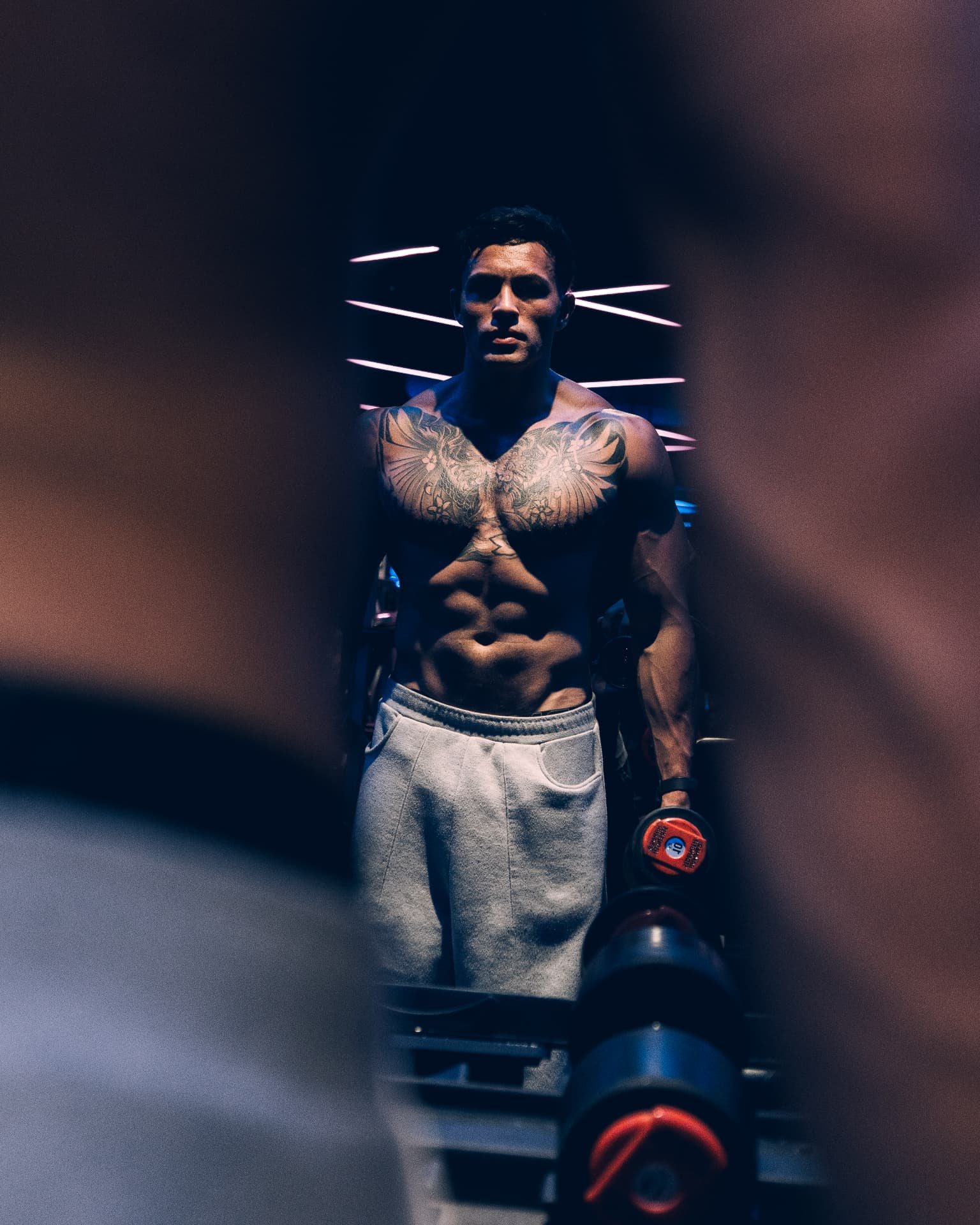 Craig O’Meara framed between dumbbells in the gym