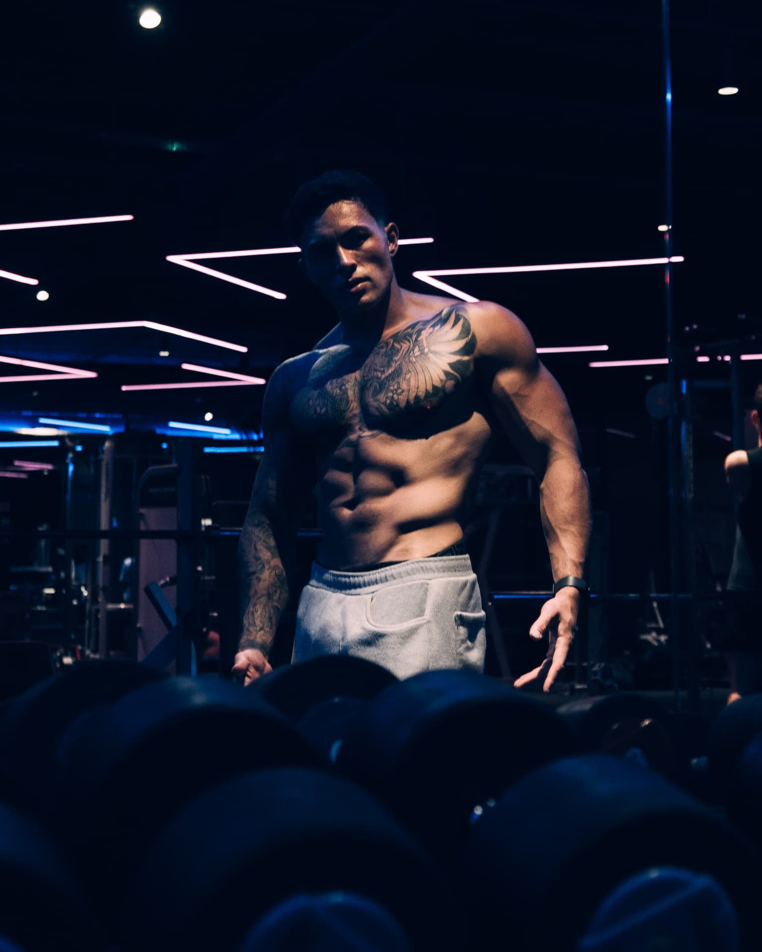 Craig O’Meara standing behind a dumbbell rack in the gym